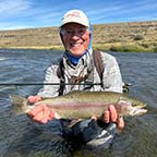 Matt Nagler Professional Fisherman holding a Rainbow Trout at Tierra Salvaje La Angelita Luxury Fishing Patagonia Experience